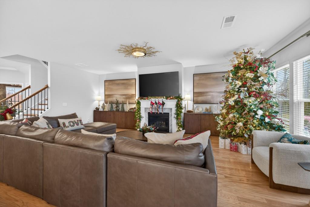 7277 Maple Brook Lane Flowery Branch, GA 30542 - Photo 15 of 93 a living room with furniture a fireplace and a potted plant