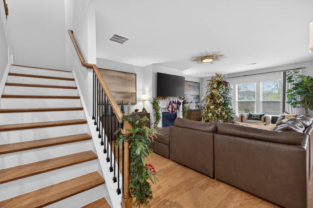 7277 Maple Brook Lane Flowery Branch, GA 30542 - Photo 17 of 93 a living room with furniture and a chandelier