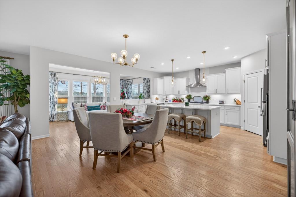7277 Maple Brook Lane Flowery Branch, GA 30542 - Photo 19 of 93 a living room with kitchen and kitchen island furniture