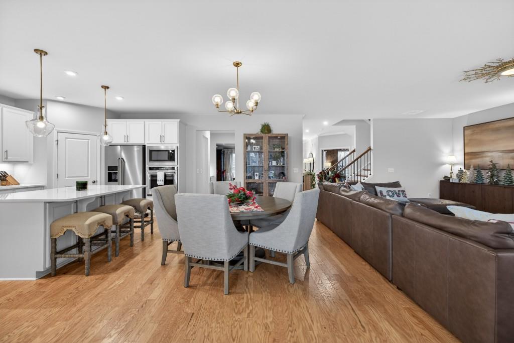 7277 Maple Brook Lane Flowery Branch, GA 30542 - Photo 20 of 93 a view of a dining room with furniture and wooden floor