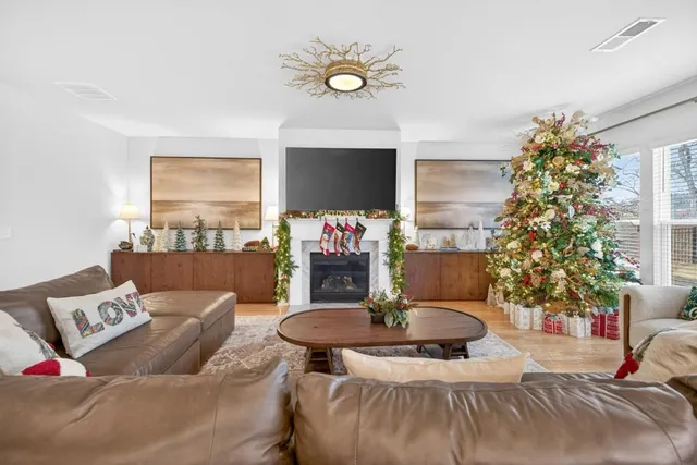 a living room with furniture and a chandelier
