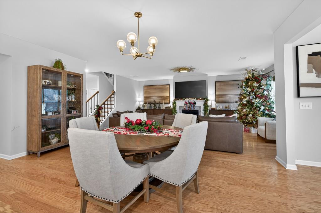 7277 Maple Brook Lane Flowery Branch, GA 30542 - Photo 32 of 93 a living room with furniture kitchen view and a chandelier
