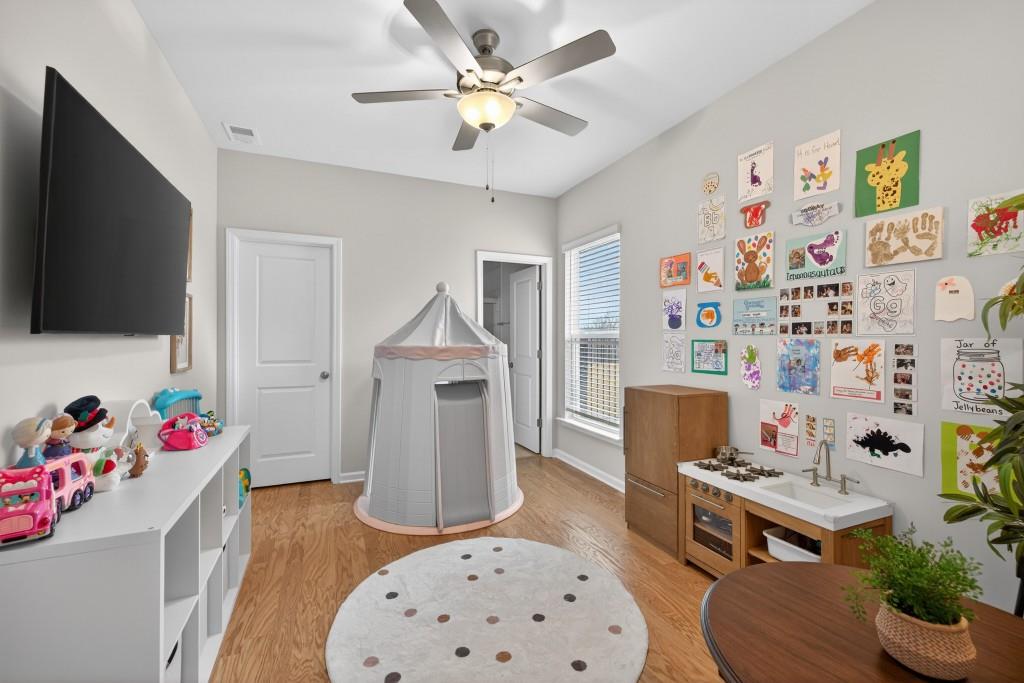 7277 Maple Brook Lane Flowery Branch, GA 30542 - Photo 36 of 93 a living room with furniture and a flat screen tv
