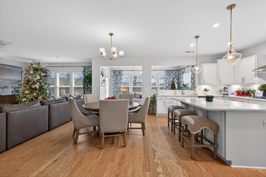 7277 Maple Brook Lane Flowery Branch, GA 30542 - Photo 39 of 93 a dining room with furniture and wooden floor