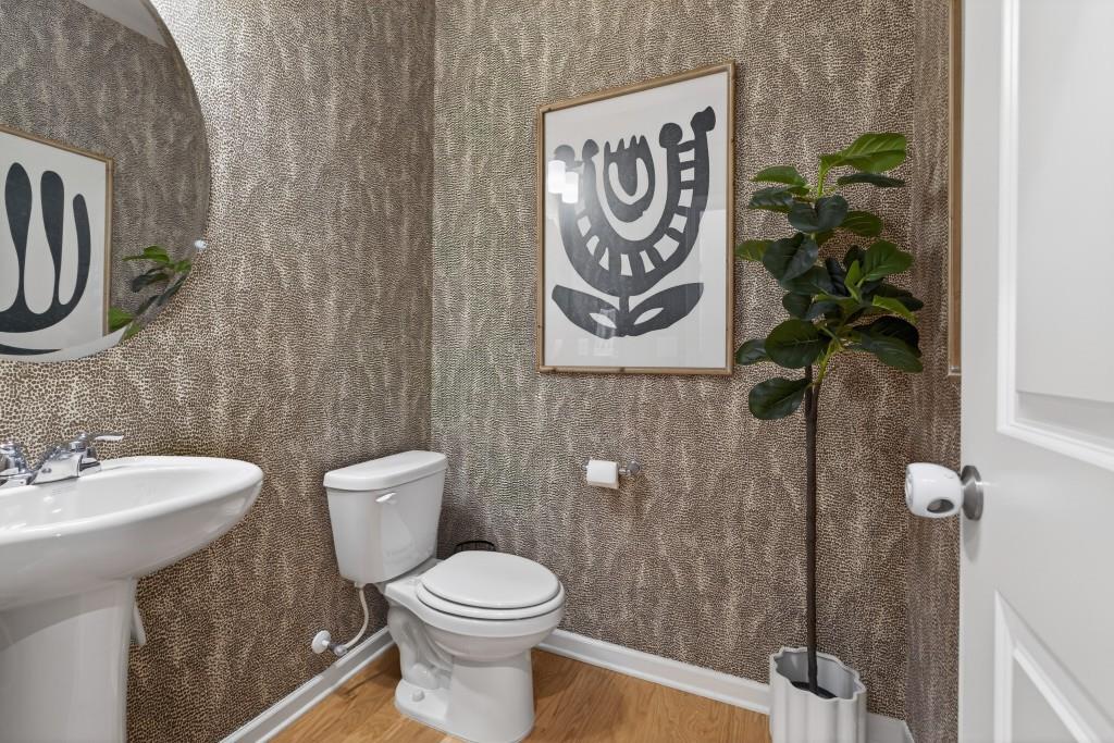 7277 Maple Brook Lane Flowery Branch, GA 30542 - Photo 40 of 93 a bathroom with a toilet sink and mirror