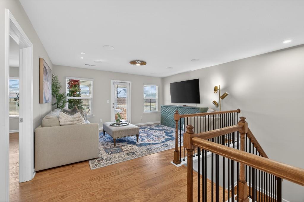 7277 Maple Brook Lane Flowery Branch, GA 30542 - Photo 45 of 93 a bedroom with furniture and a flat screen tv