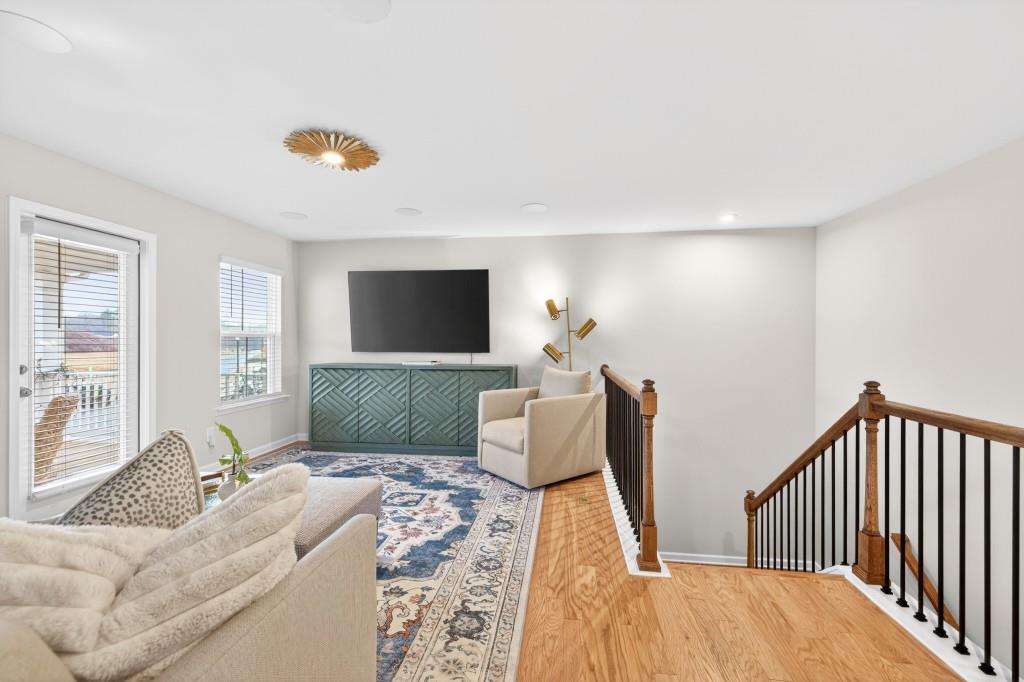 7277 Maple Brook Lane Flowery Branch, GA 30542 - Photo 46 of 93 a living room with furniture floor and a flat screen tv