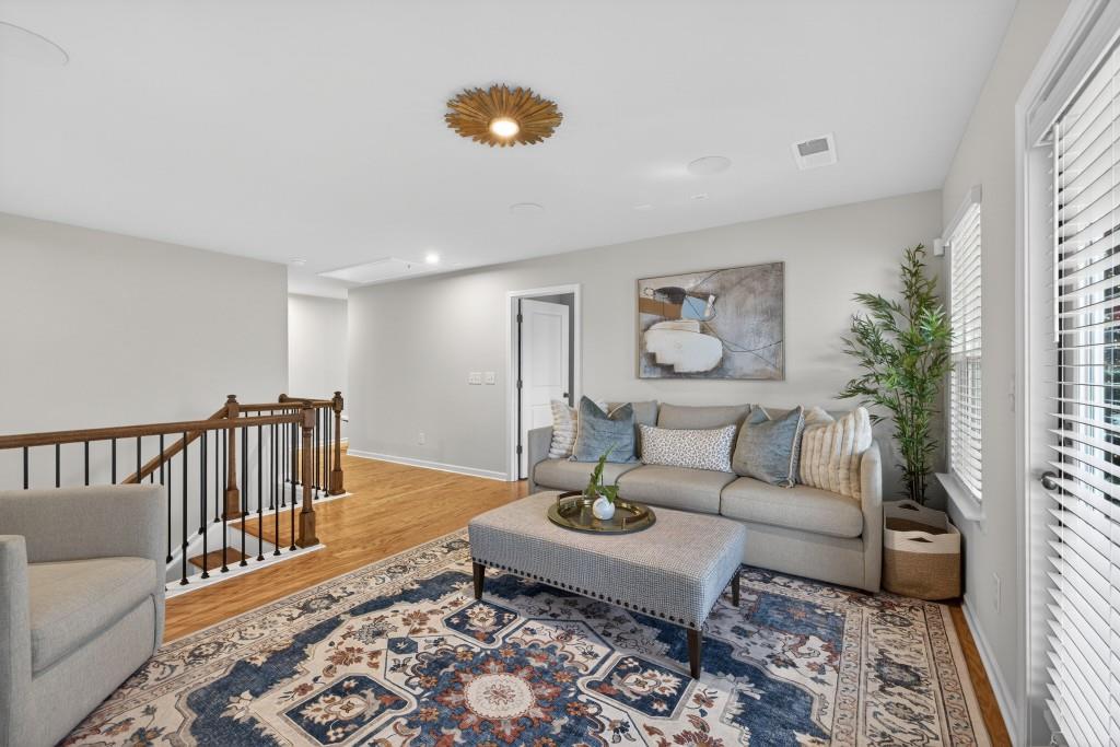 7277 Maple Brook Lane Flowery Branch, GA 30542 - Photo 47 of 93 a living room with furniture and wooden floor