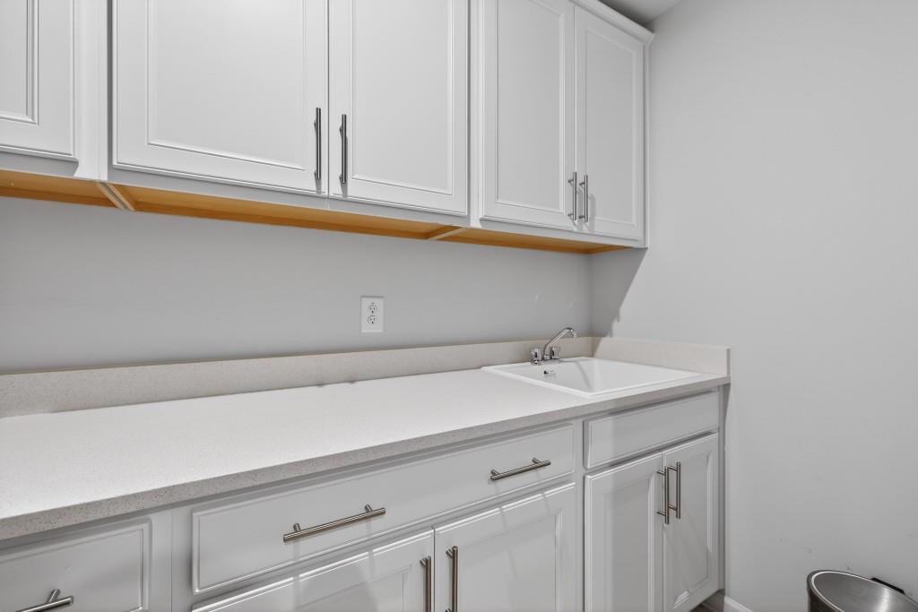 7277 Maple Brook Lane Flowery Branch, GA 30542 - Photo 57 of 93 a bathroom with a sink and cabinets