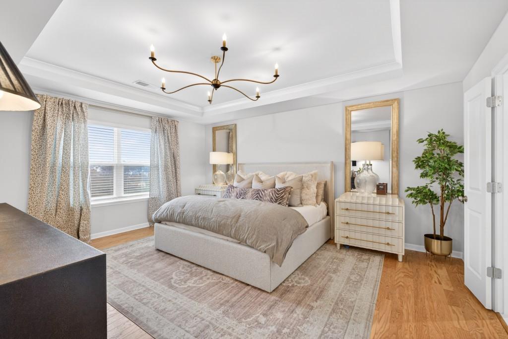 7277 Maple Brook Lane Flowery Branch, GA 30542 - Photo 59 of 93 a spacious bedroom with a bed and a large window