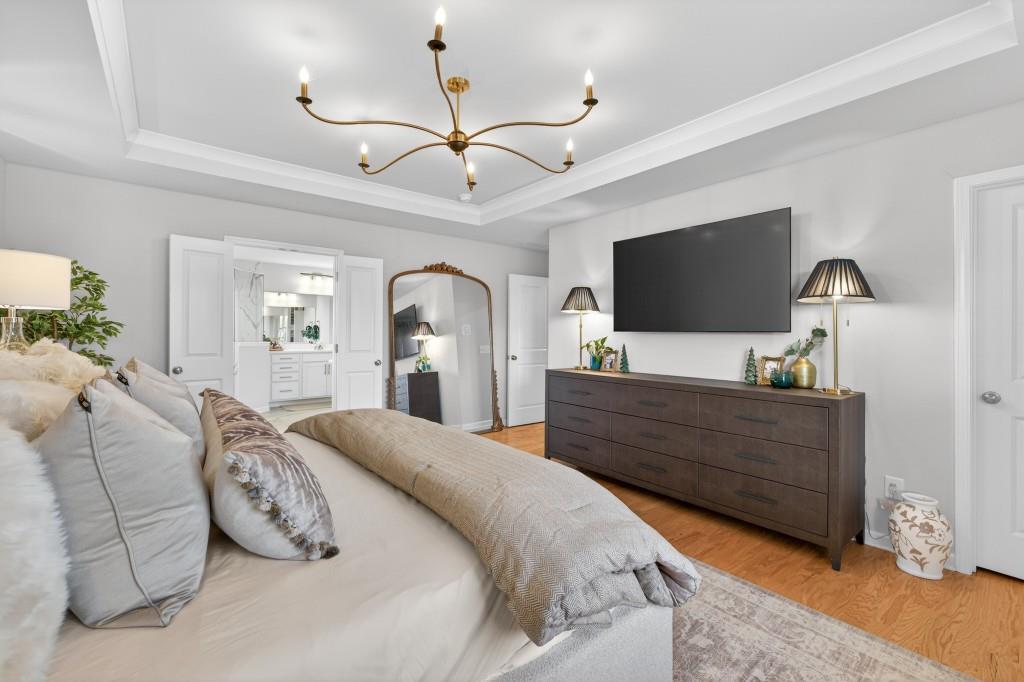 7277 Maple Brook Lane Flowery Branch, GA 30542 - Photo 61 of 93 a bed room with furniture and a flat screen tv