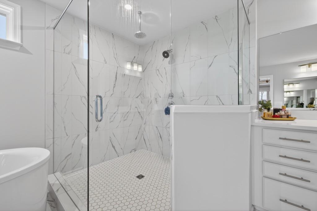 7277 Maple Brook Lane Flowery Branch, GA 30542 - Photo 65 of 93 a bathroom with a shower a sink a toilet and a shower