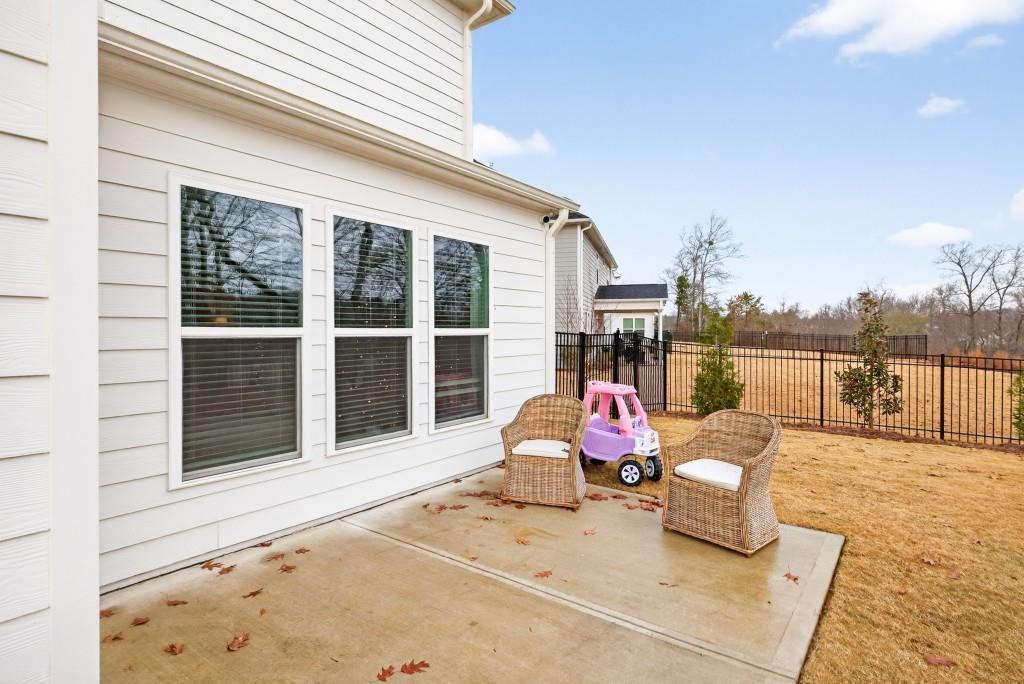 7277 Maple Brook Lane Flowery Branch, GA 30542 - Photo 72 of 93 a view of a roof deck with the couches and floor to ceiling window next to a yard