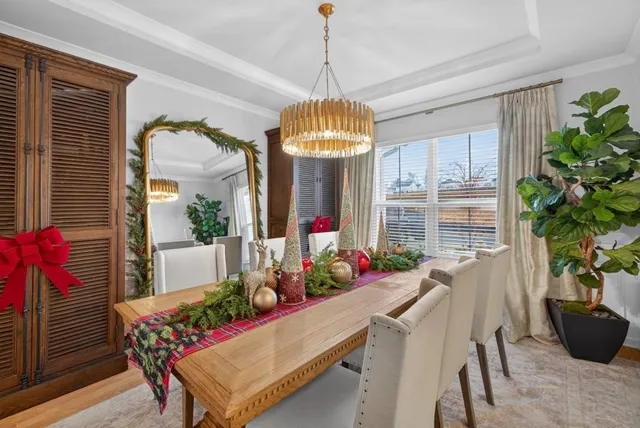 a living room with furniture a fireplace and a potted plant
