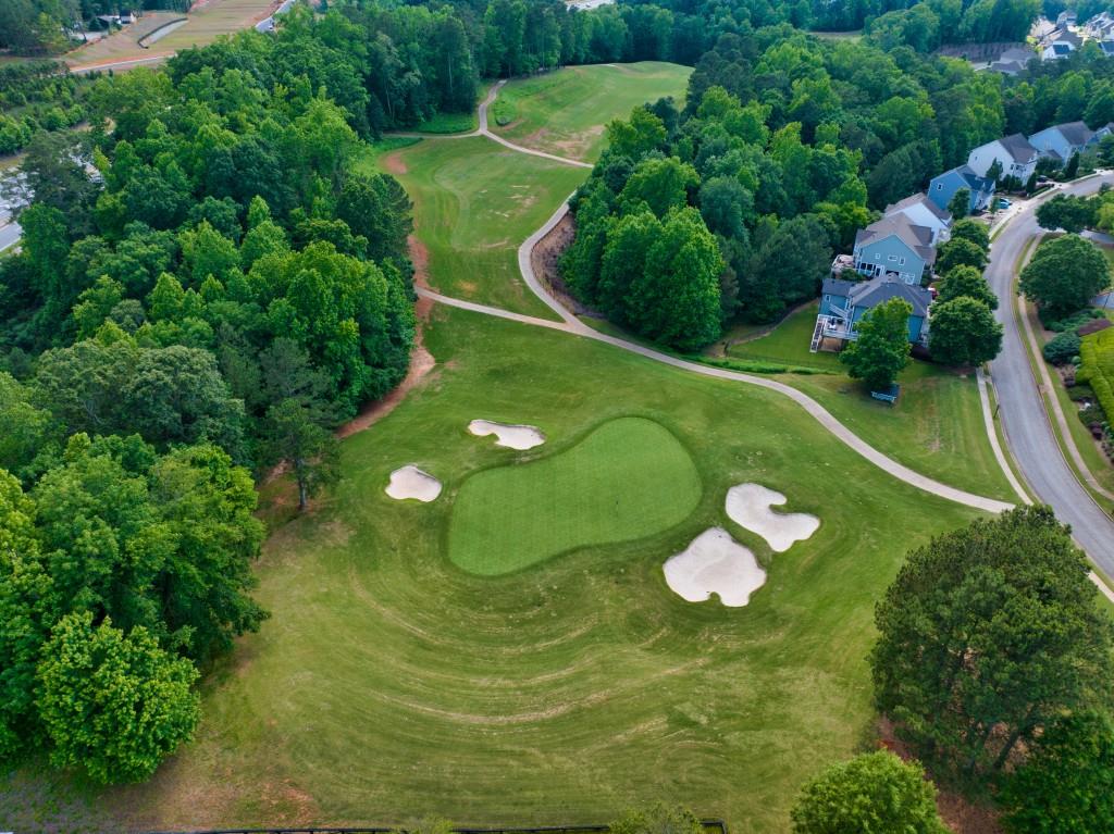 7277 Maple Brook Lane Flowery Branch, GA 30542 - Photo 93 of 93 a view of a golf course with a swimming pool