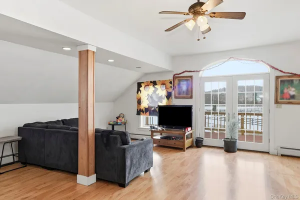 a view of a livingroom with workspace and a flat screen tv