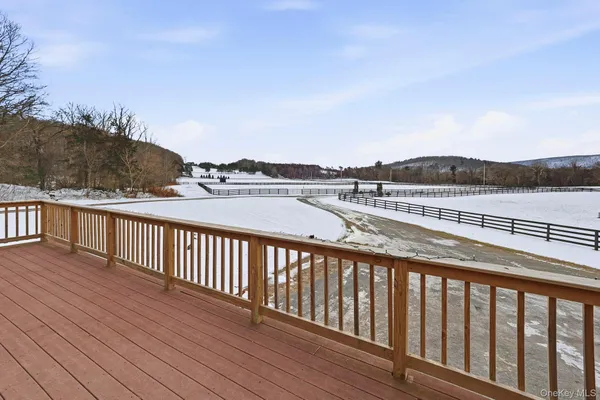 a balcony with wooden floor and lake view