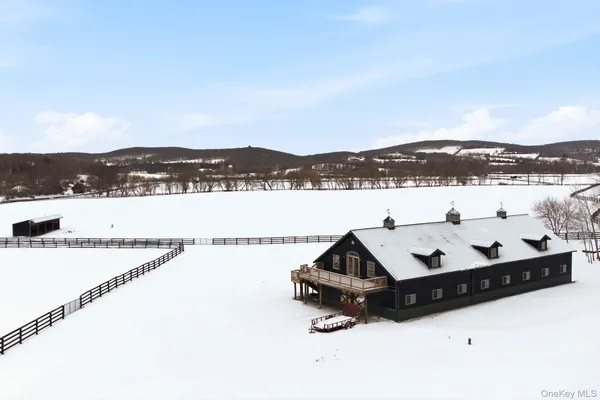 a view of a house with a wooden deck