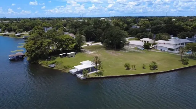an aerial view of a house with a yard