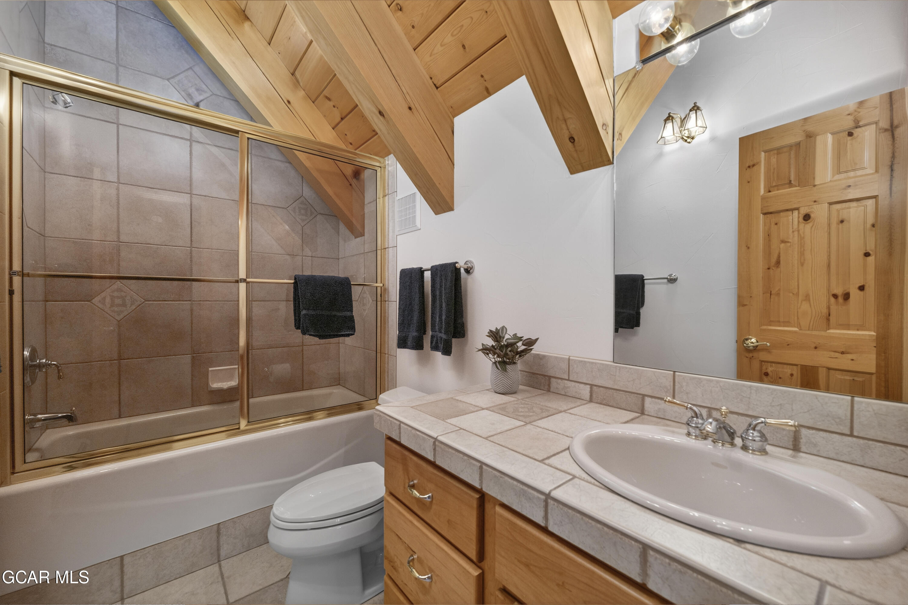 400 Ridge Road Tabernash, CO 80478 - Photo 12 of 50 a bathroom with a granite countertop sink a toilet and shower