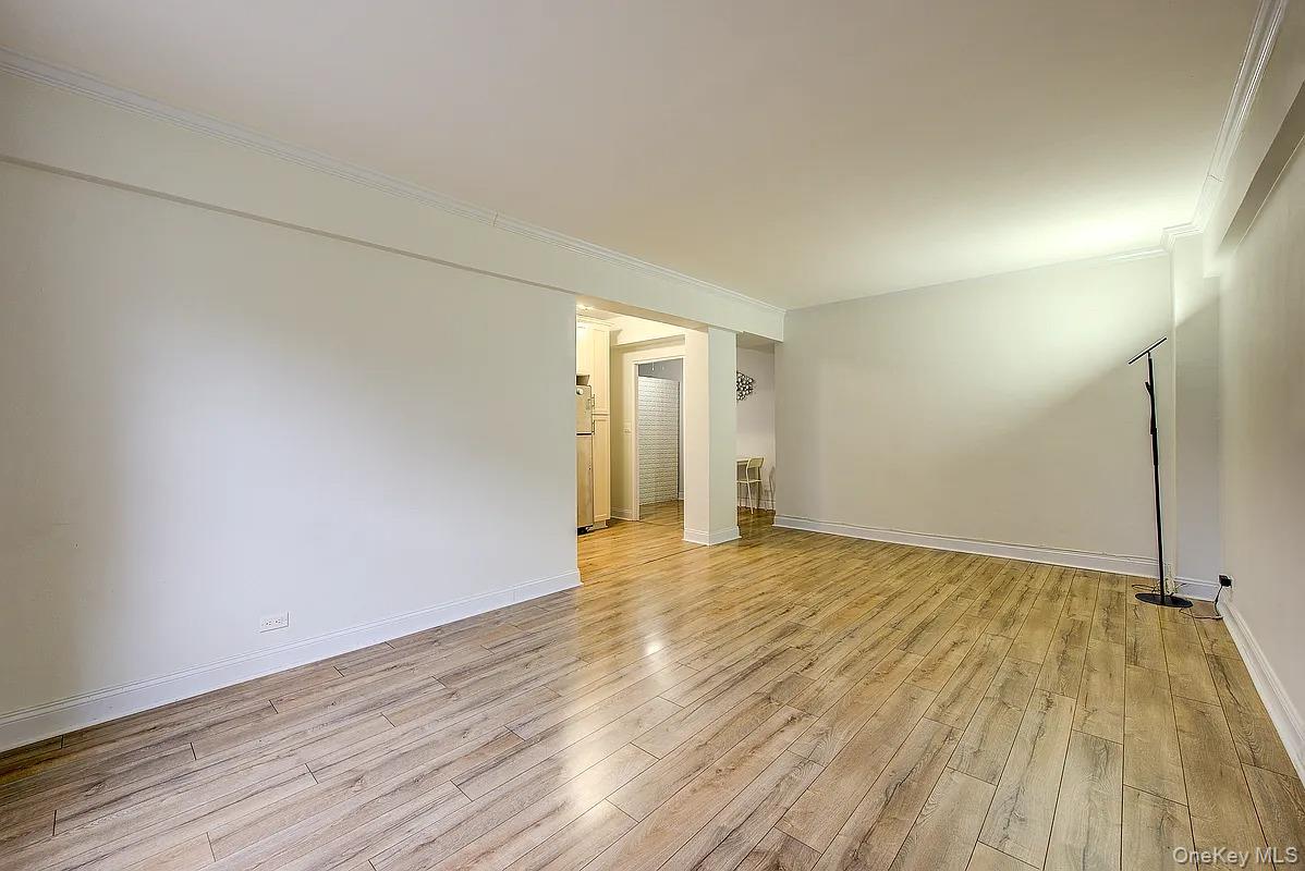 67-76 Booth Street, Unit 4F Queens, NY 11375 - Photo 14 of 33 a view of empty room with wooden floor