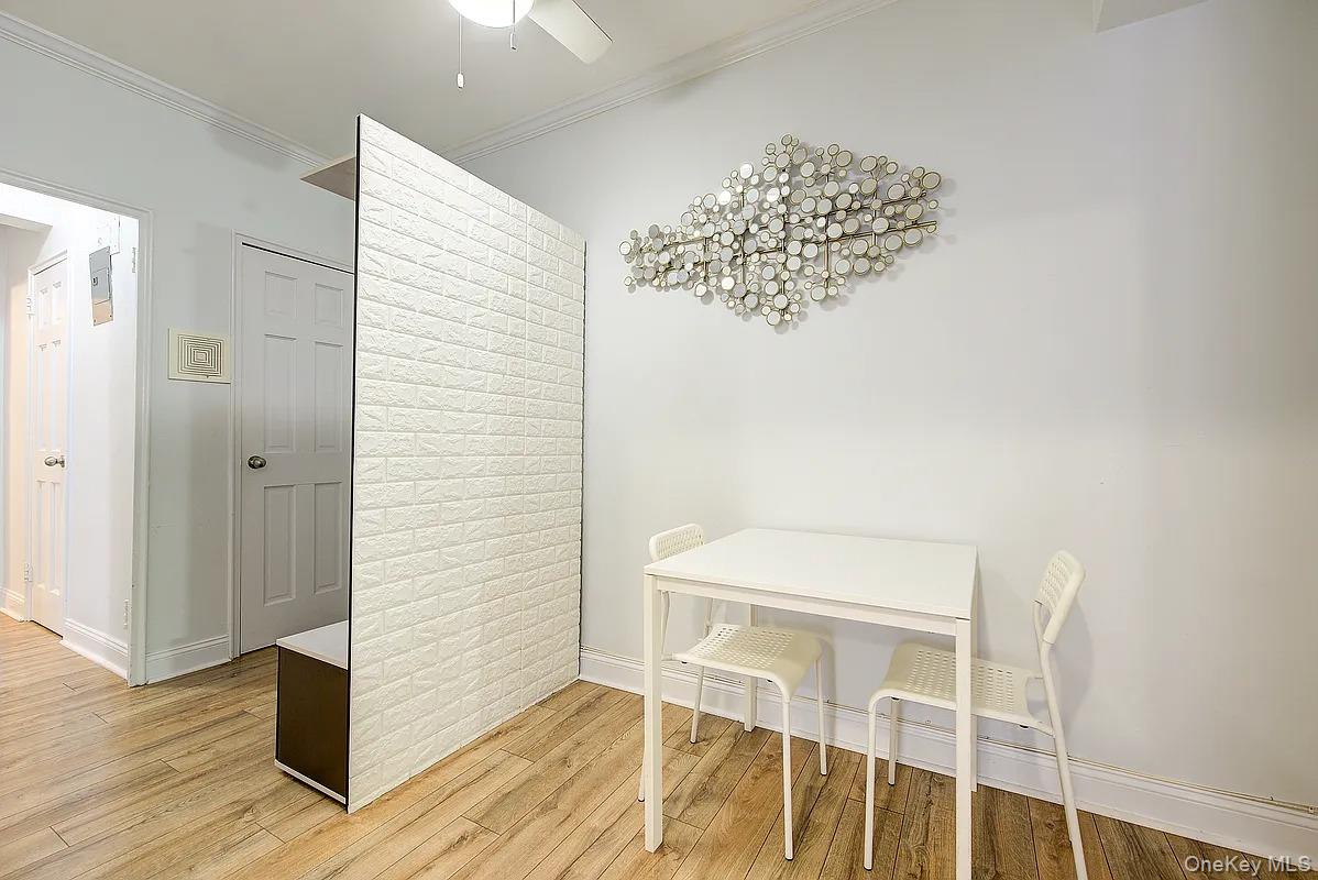 67-76 Booth Street, Unit 4F Queens, NY 11375 - Photo 16 of 33 a view of a room with wooden floor and staircase