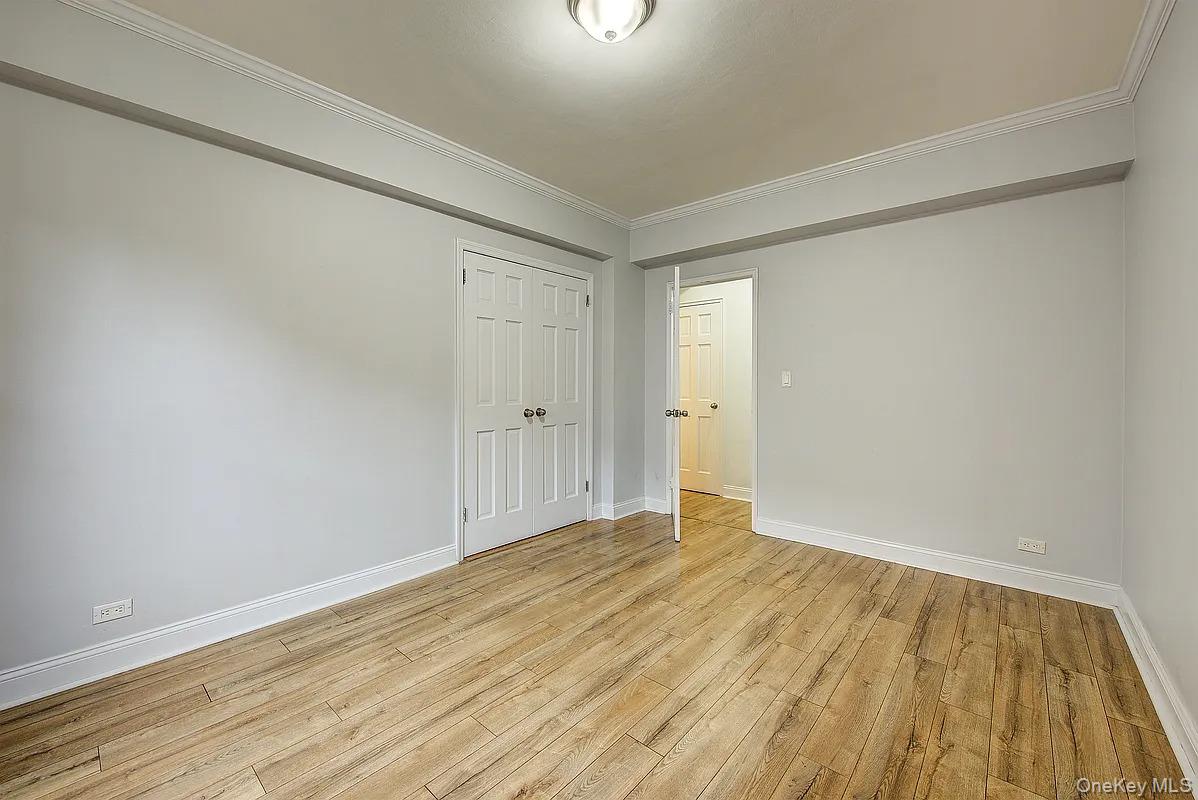 67-76 Booth Street, Unit 4F Queens, NY 11375 - Photo 19 of 33 a view of an empty room and wooden floor