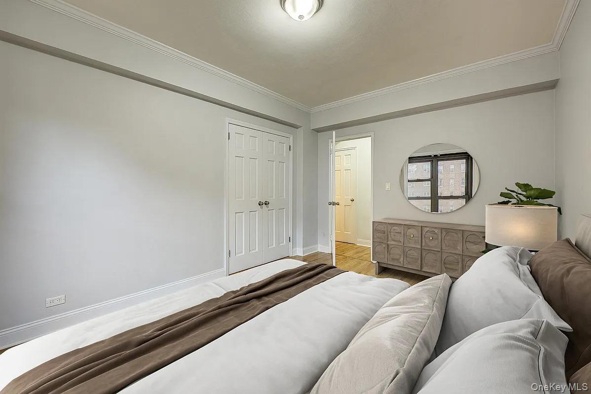 67-76 Booth Street, Unit 4F Queens, NY 11375 - Photo 20 of 33 a living room with a bed furniture and a window