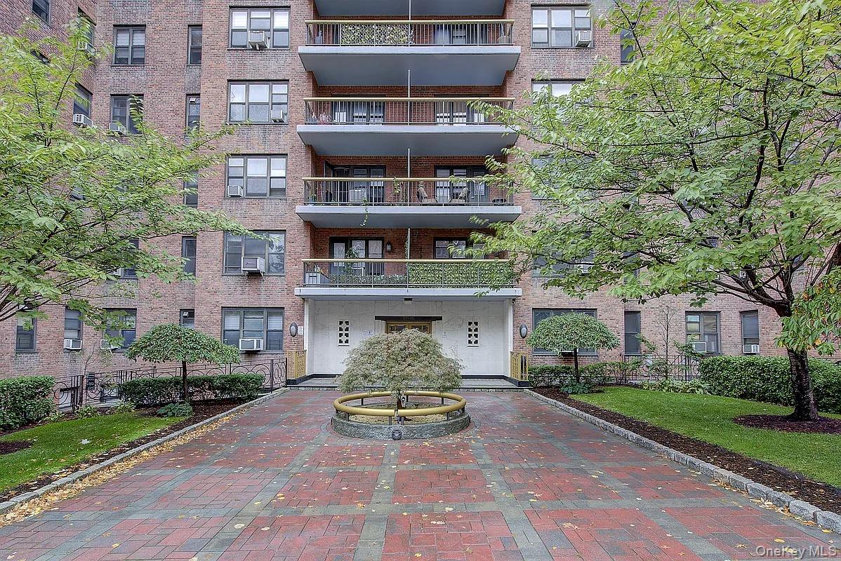 67-76 Booth Street, Unit 4F Queens, NY 11375 - Photo 2 of 33 a view of a blue house with a yard and plants
