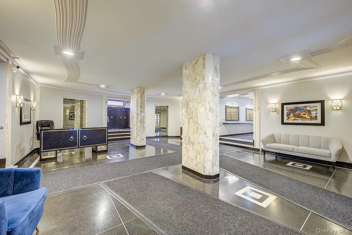 67-76 Booth Street, Unit 4F Queens, NY 11375 - Photo 30 of 33 a living room with furniture a rug and paintings on the wall