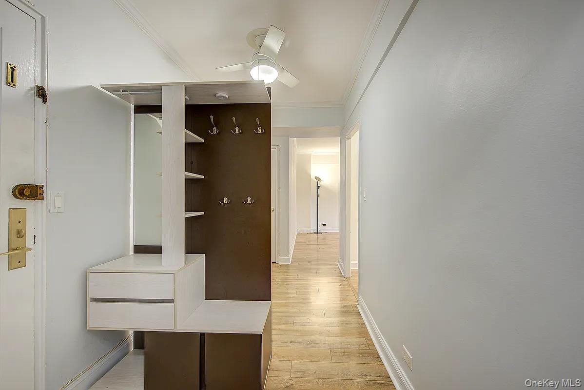 67-76 Booth Street, Unit 4F Queens, NY 11375 - Photo 3 of 33 a view of a hallway with wooden floor and staircase