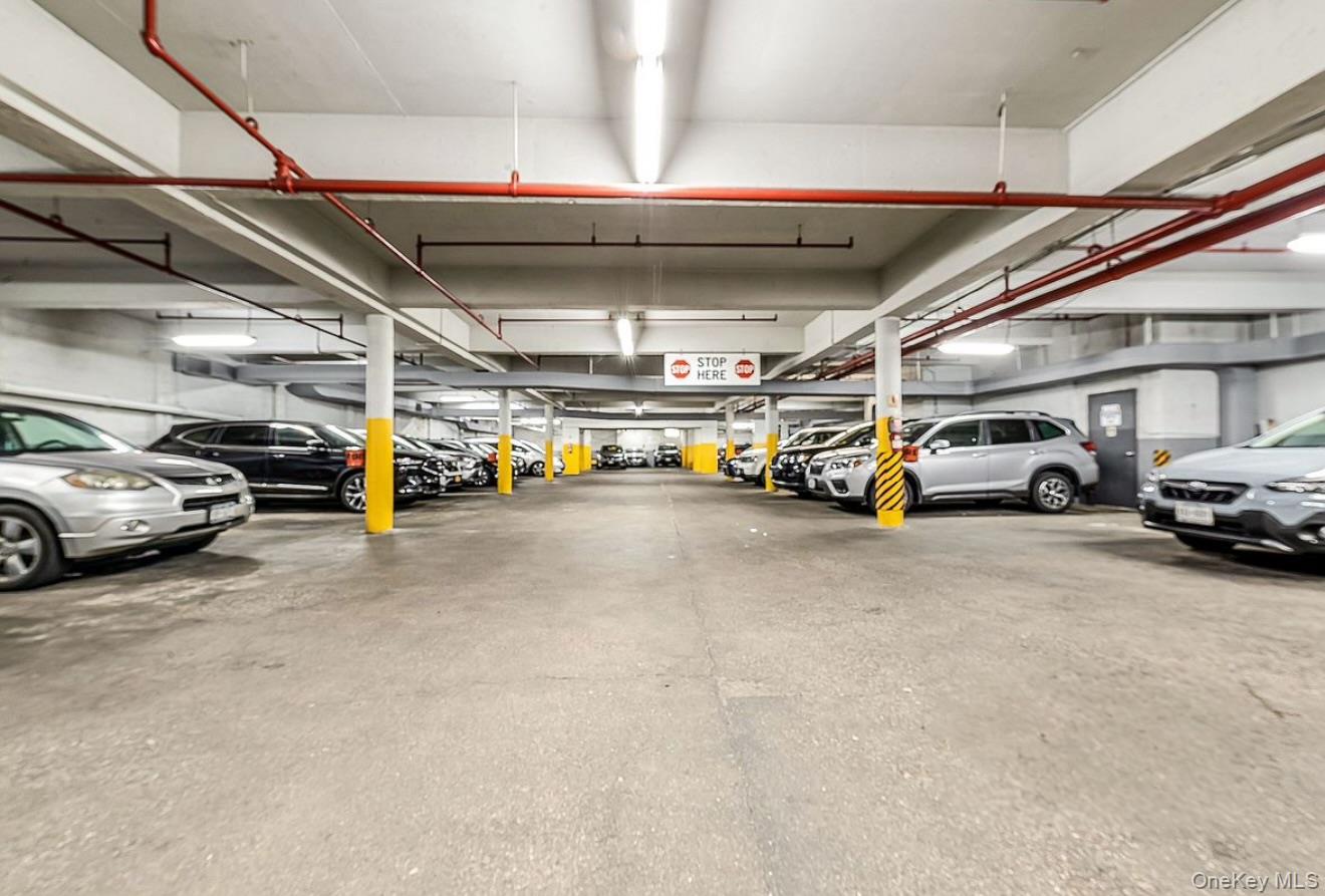 67-76 Booth Street, Unit 4F Queens, NY 11375 - Photo 32 of 33 a view of parking garage with cars