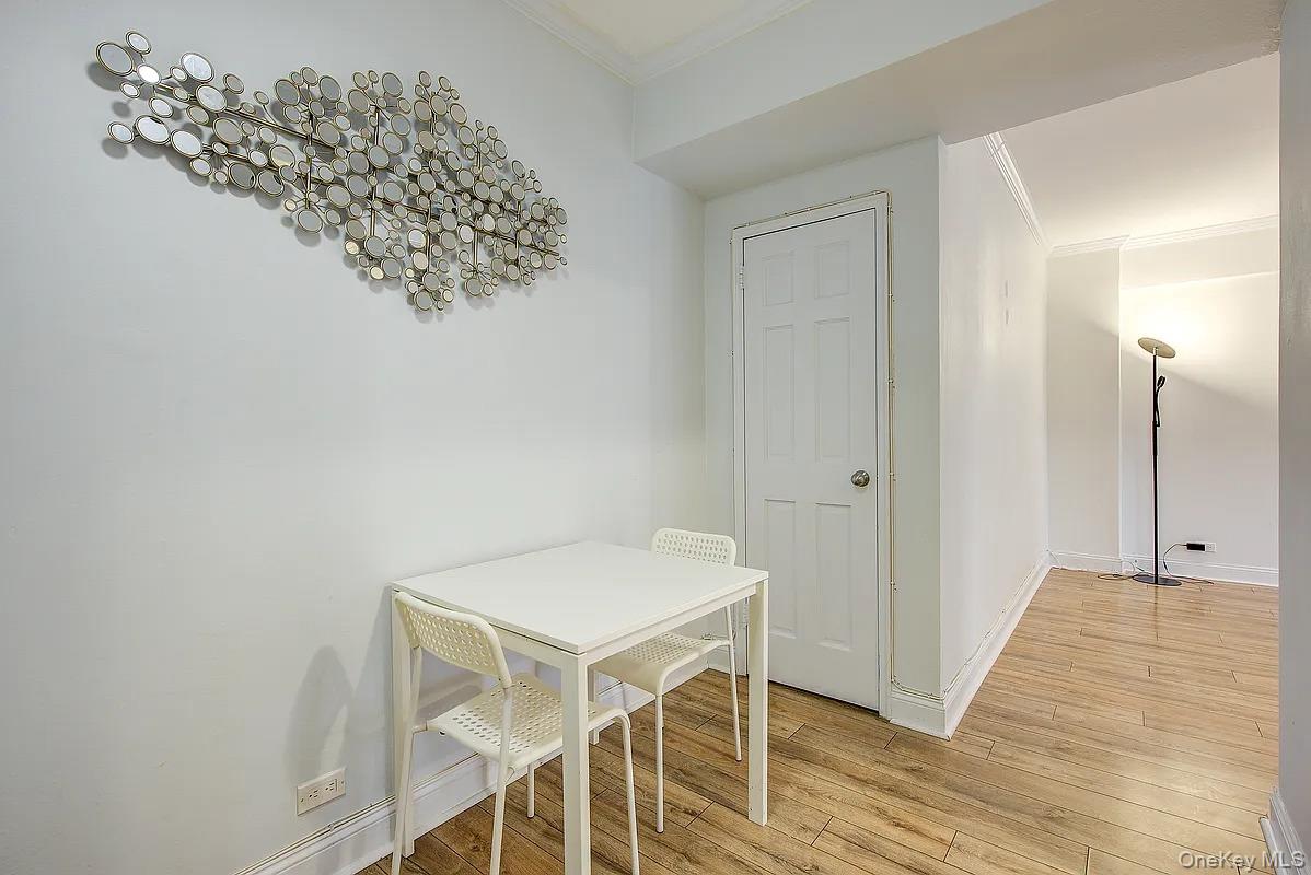 67-76 Booth Street, Unit 4F Queens, NY 11375 - Photo 4 of 33 a view of a hallway with wooden floor and entryway