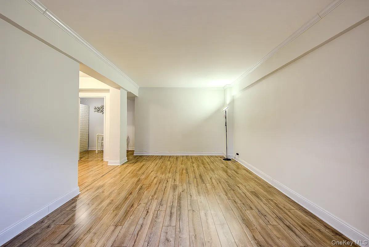 67-76 Booth Street, Unit 4F Queens, NY 11375 - Photo 5 of 33 a view of an empty room and wooden floor