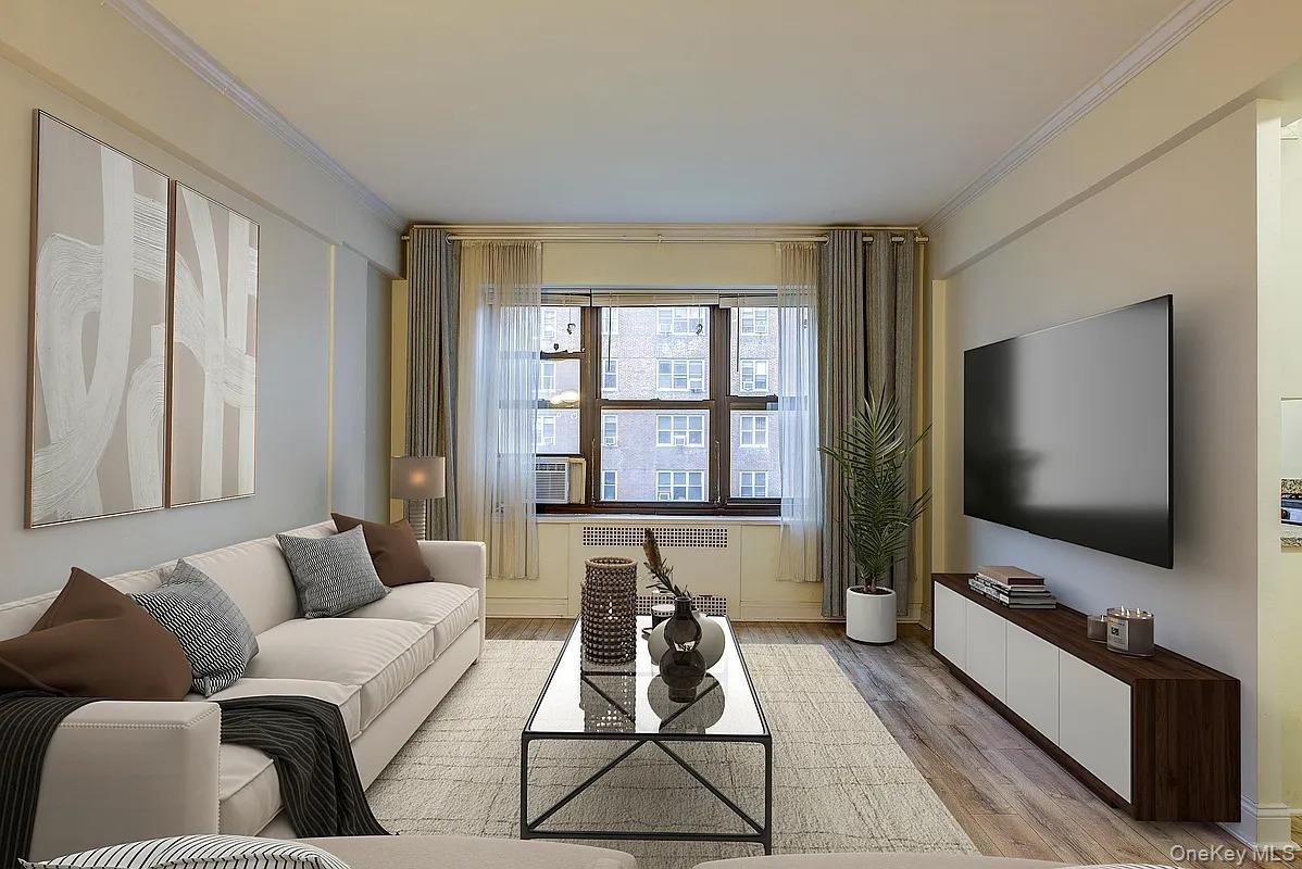 67-76 Booth Street, Unit 4F Queens, NY 11375 - Photo 8 of 33 a living room with furniture and a flat screen tv