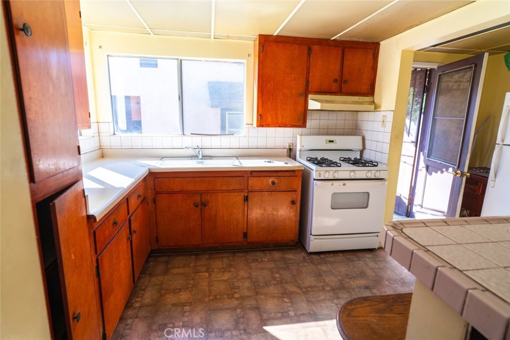 814 West Maple Street Compton, CA 90220 - Photo 5 of 13 a kitchen with a sink stove and cabinets