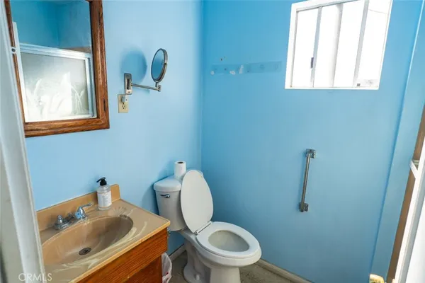 a white toilet sitting next to a bathroom sink