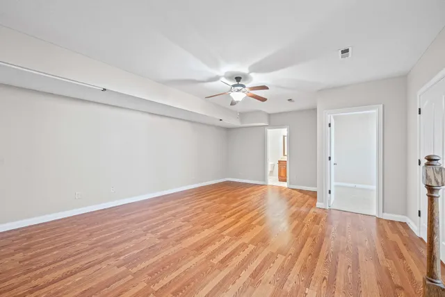 a view of an empty room with wooden floor