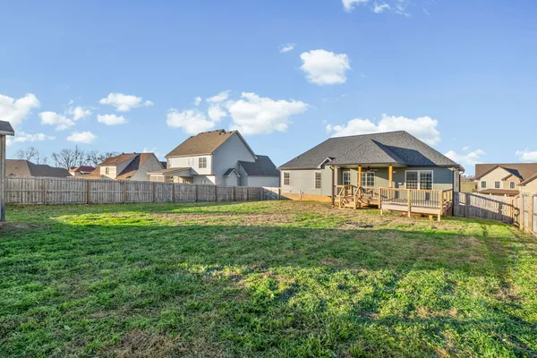 a aerial view of a house with swimming pool and a yard