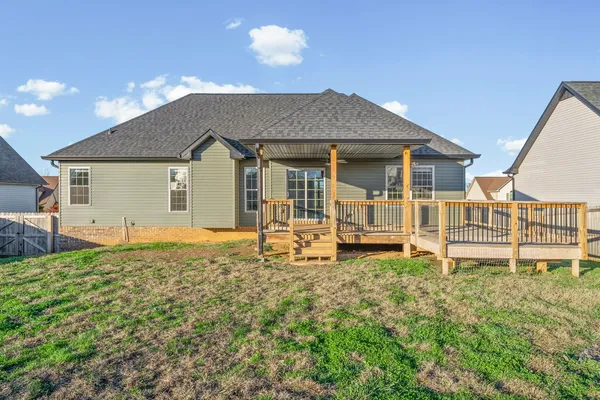 a house that has a big yard with wooden fence
