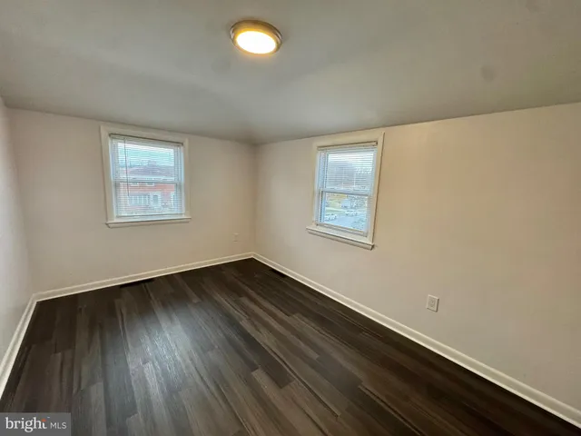a view of a room with wooden floor and window