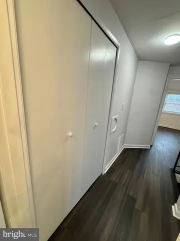 a view of a kitchen with refrigerator and window