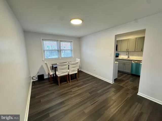a kitchen with sink cabinets and wooden floor