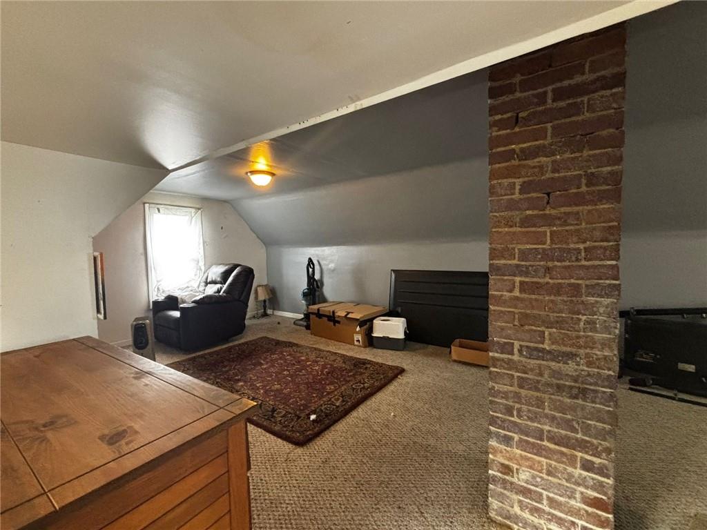 135 Hamilton Avenue Vandergrift, PA 15690 - Photo 15 of 25 a living room with fireplace furniture and a lamp