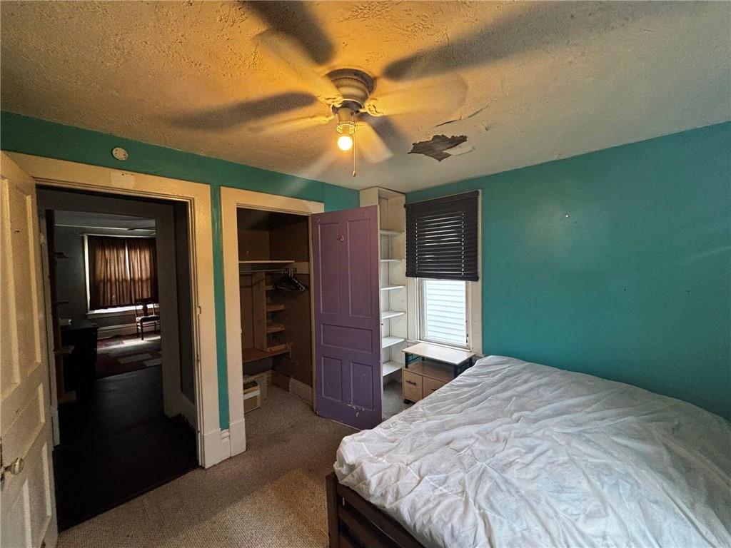 135 Hamilton Avenue Vandergrift, PA 15690 - Photo 17 of 25 a bedroom with a bed and a ceiling fan