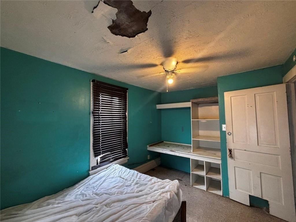 135 Hamilton Avenue Vandergrift, PA 15690 - Photo 18 of 25 a bedroom with a bed and a ceiling fan