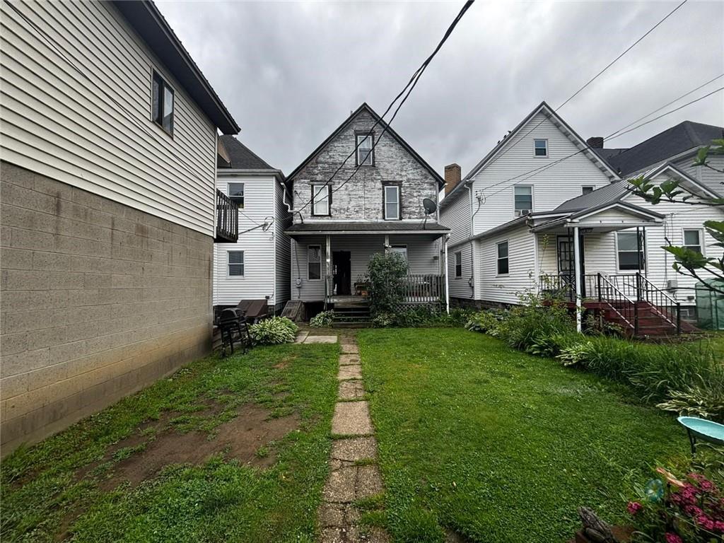 135 Hamilton Avenue Vandergrift, PA 15690 - Photo 25 of 25 a front view of a house with a yard and porch
