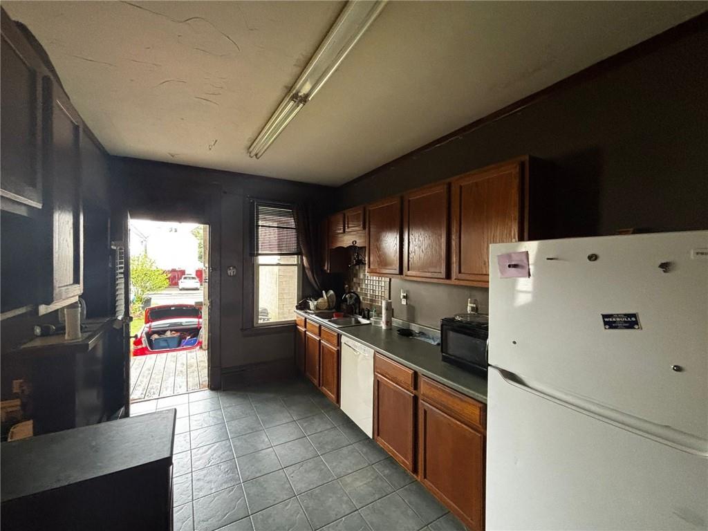 135 Hamilton Avenue Vandergrift, PA 15690 - Photo 7 of 25 a kitchen with a refrigerator and a stove top oven