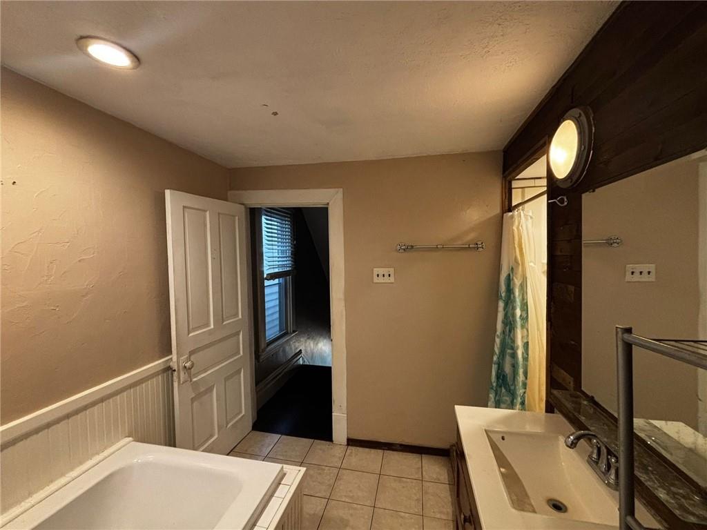 135 Hamilton Avenue Vandergrift, PA 15690 - Photo 10 of 25 a bathroom with a sink and a large mirror