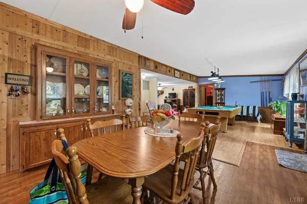 a dining room with furniture a wooden floor and chandelier